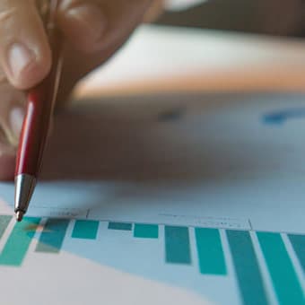 worker pointing with pencil at charts