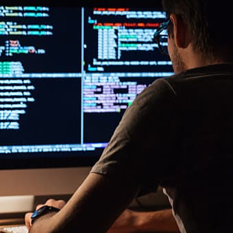 ddos attack hacker coding at desk